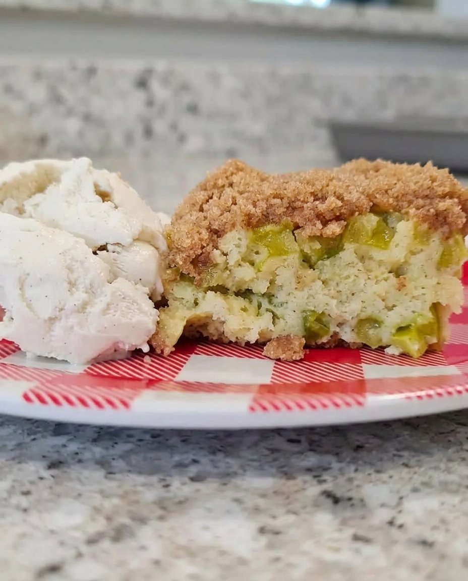 Strawberry Rhubarb Cake 3 12 Freshly chopped rhubarb and strawberries coated in red Jell-O powder and sugar in a glass bowl.