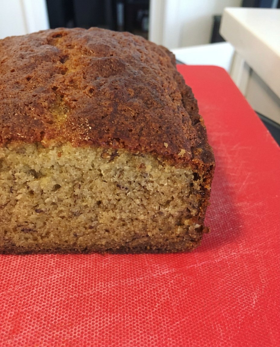 Warm banana coffee cake served alongside a hot cup of coffee
