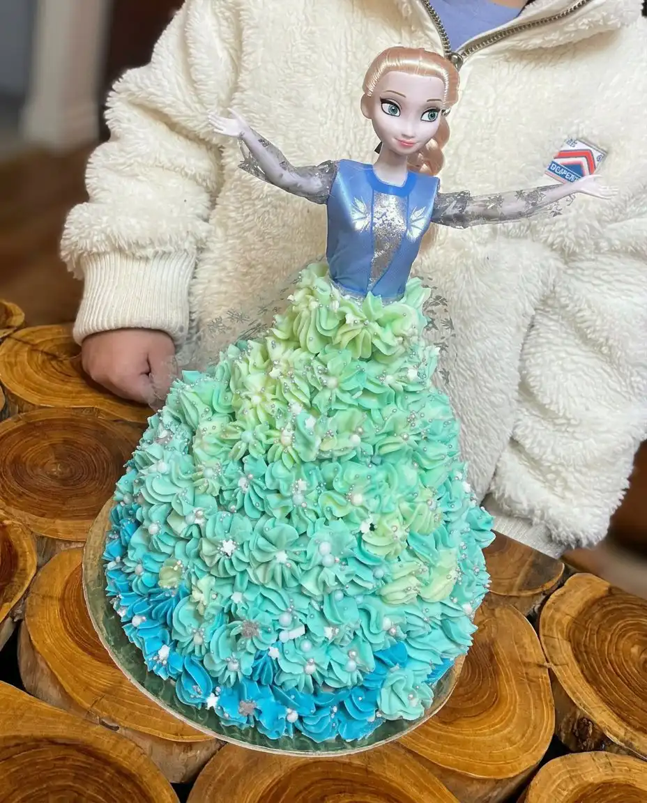 Elsa Cake 14 A slice of moist vanilla Elsa cake on a white plate