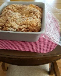 A close up shot of a slice of Strawberry Rhubarb Cake 3 showing the moist fruit layer at the bottom.