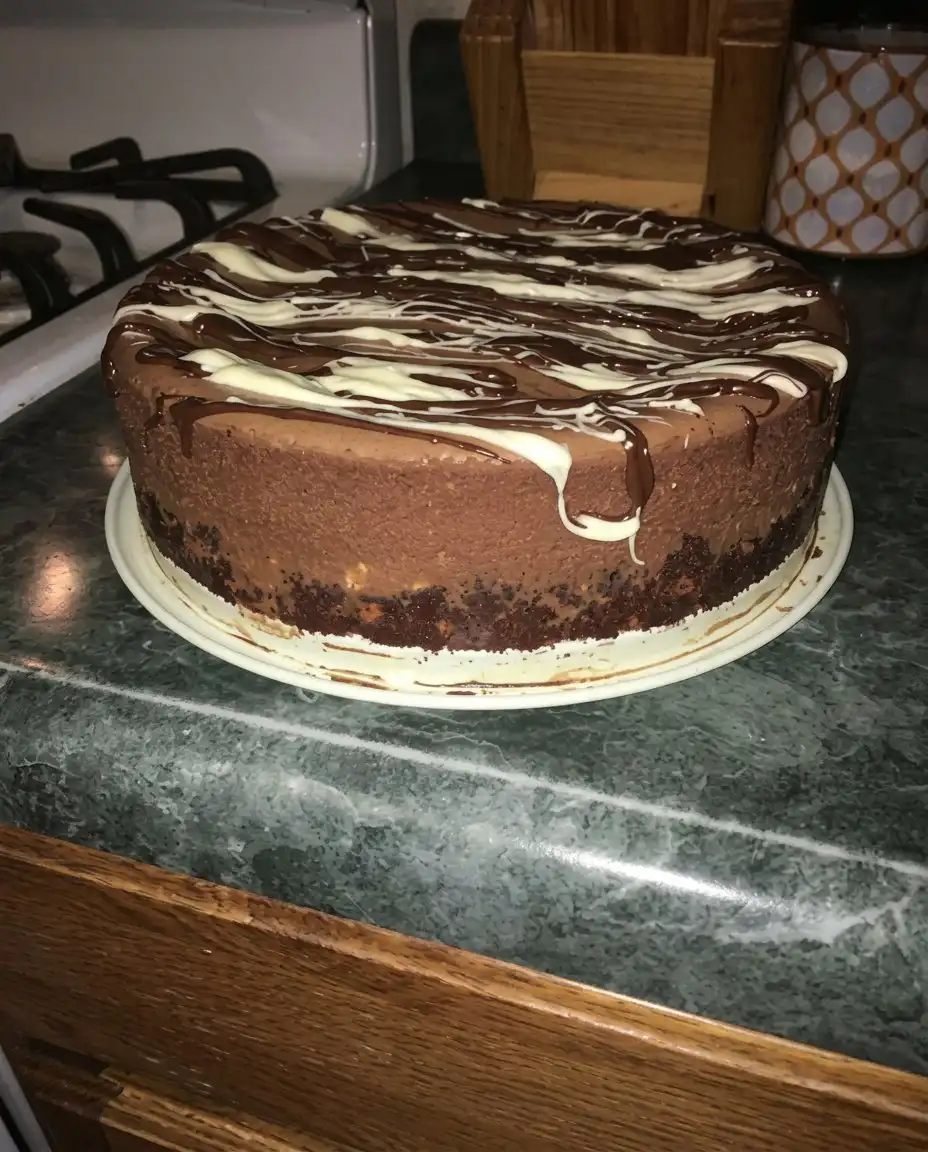 Chocolate Truffle Cake 13 A whisk lifting whipped chocolate ganache showing soft peaks