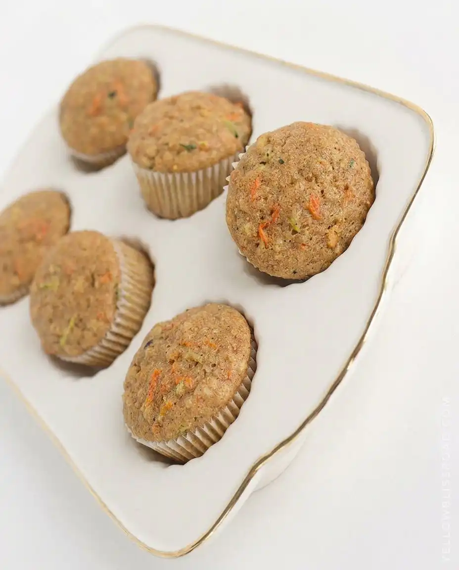 Cross section of a zucchini carrot oatmeal muffin showing the even distribution of ingredients