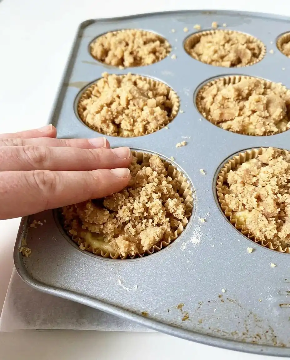 Zucchini Coffee Cake Muffins 13 Zucchini coffee cake muffins rising in a muffin tin inside the oven