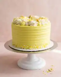 A clean vertical slice of Banana Pudding Layer Cake showing the distinct pudding and wafer layers.
