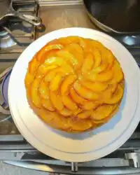 A golden Bourbon Peach Upside Down Cake with caramelized peach wedges on top.