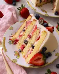 A four layer Chantilly Bliss cake with fresh berries and cream