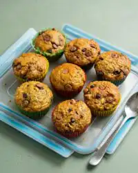 A close up shot of moist Chocolate Chip Zucchini Muffins cooling on a wire rack.