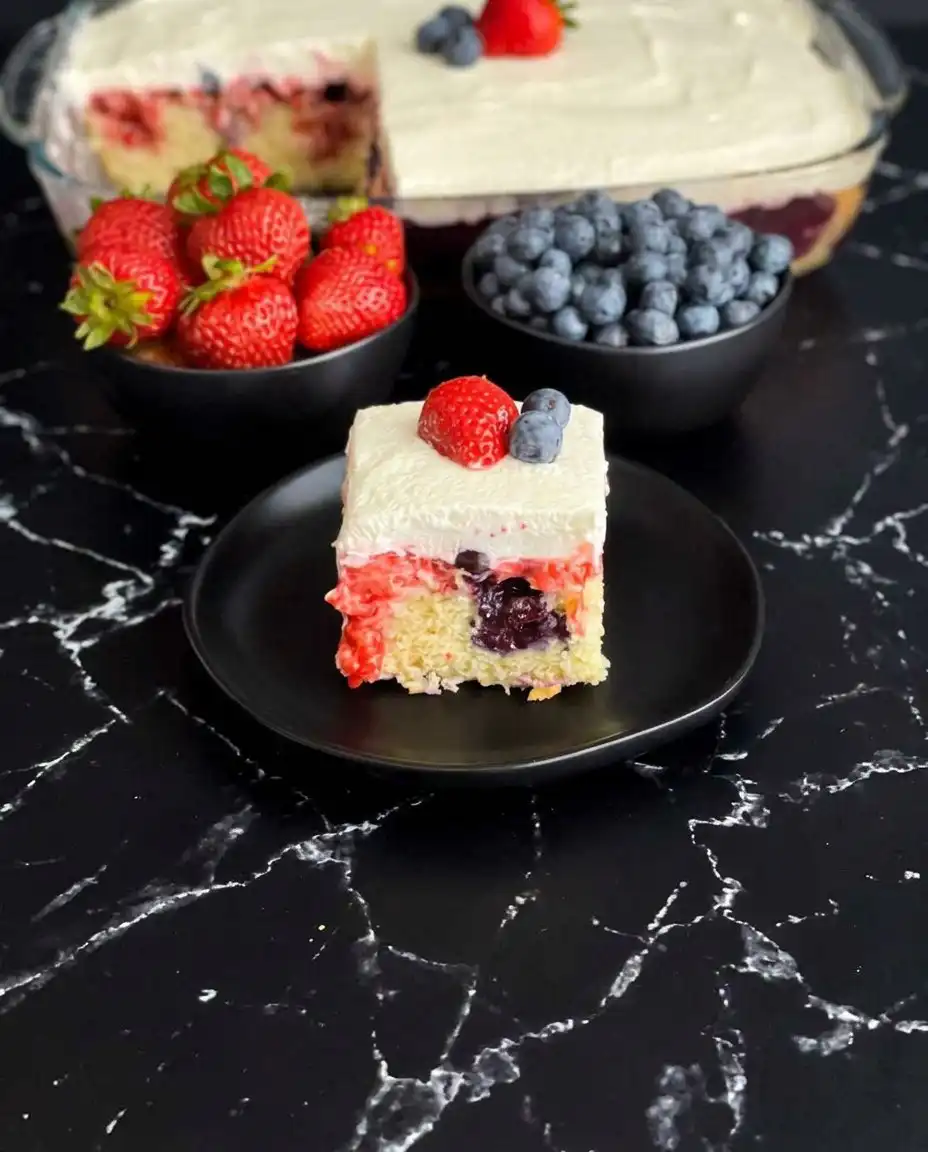 Summer Berry Poke Cake 13 Stiff peaks formed by the heavy cream and cream cheese topping, demonstrating structural stability.