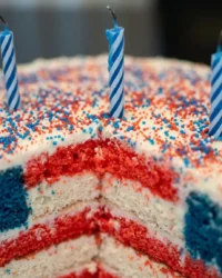 A slice of Red White and Blue Layered Flag Cake showing the internal flag pattern