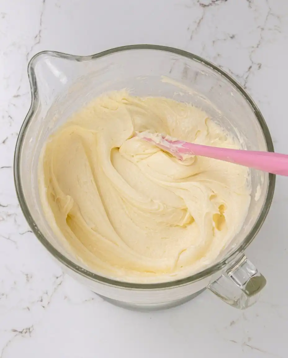 Vanilla Mousse Cake Filling 13 Hand folding whipped cream into a vanilla mousse base