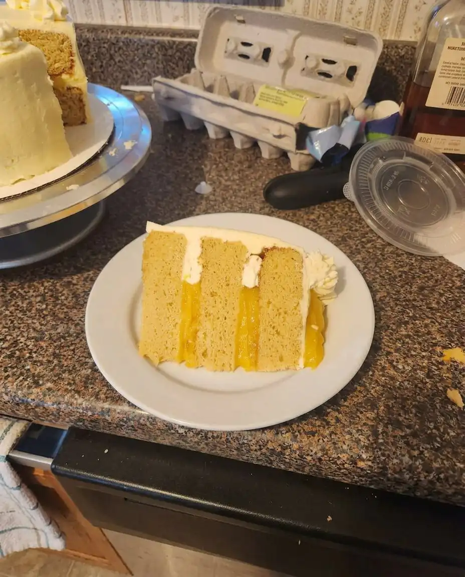 Orange Creamsicle Cake 13 Spreading smooth vanilla pudding frosting over a golden orange cake.