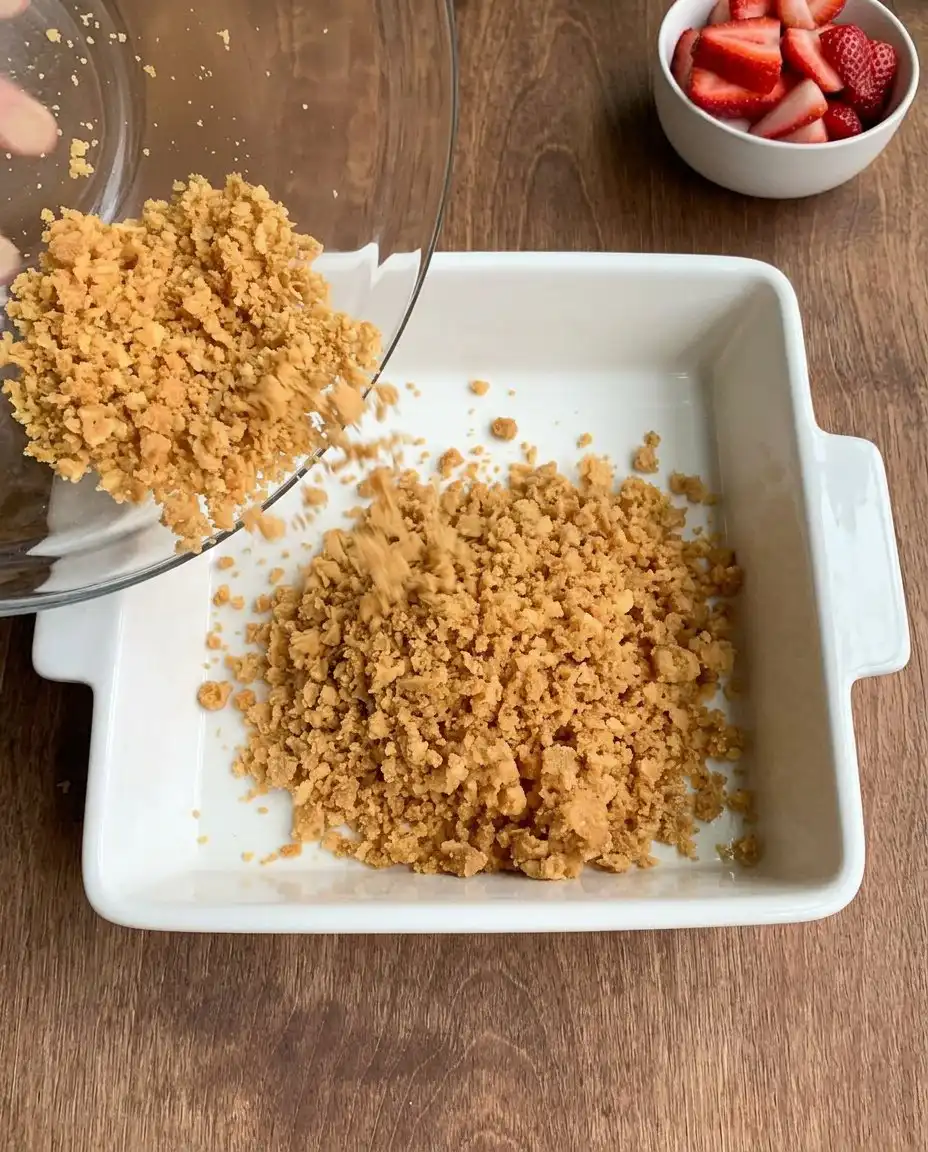 No-Bake Strawberry Dream 12 Pressing graham cracker crumbs into a baking dish for a no-bake crust