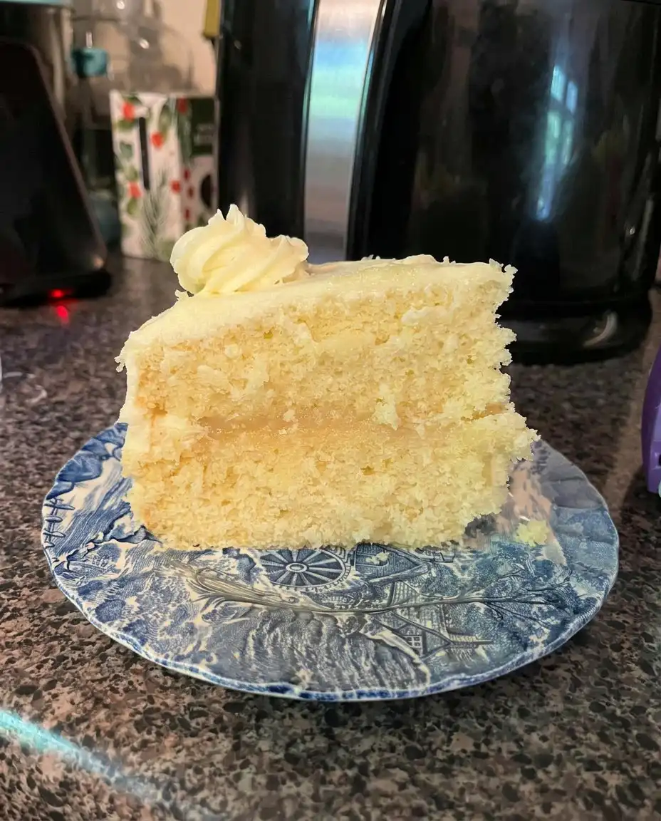 Close-up of a slice of lemon velvet cake showing the fine, tight, and moist crumb structure.