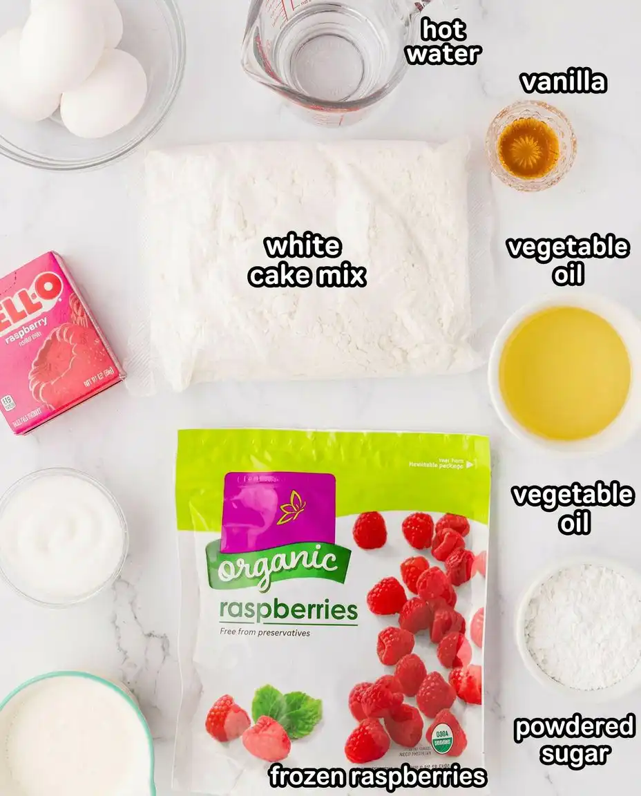 Ingredients for raspberry fluff cake including frozen raspberries, white cake mix, and heavy cream on a wooden table.