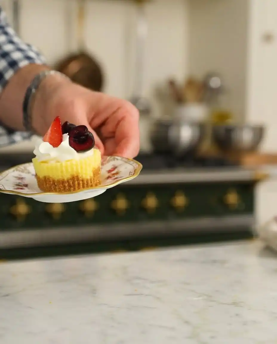 Mini cheesecake cups topped with fresh berries and cream