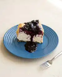 A high-angle shot of a Moist Blueberry Lemon Angel Food Cake showing its golden-brown crust.