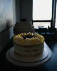 A close up view of a moist lemon blueberry cake slice showing purple berry layers.