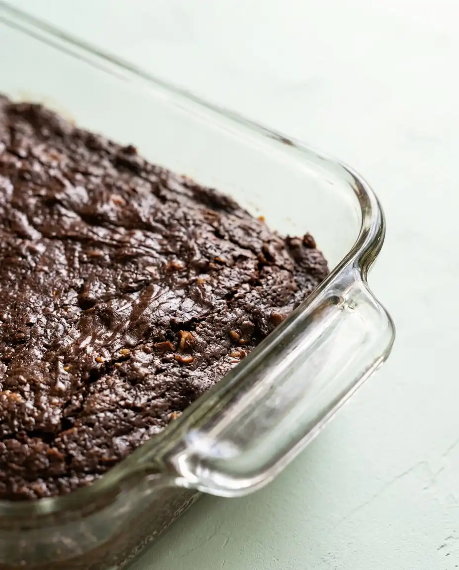 Old-Fashioned Chocolate Zucchini Cake 12 A close up of an Old-Fashioned Chocolate Zucchini Cake cooling in a baking pan.
