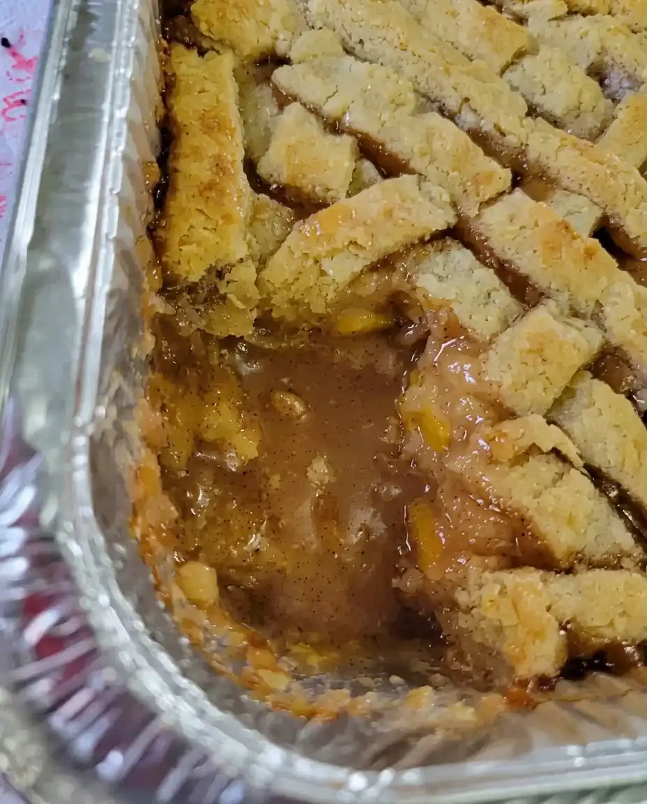 A freshly baked peach cobbler with a golden brown bubbly crust