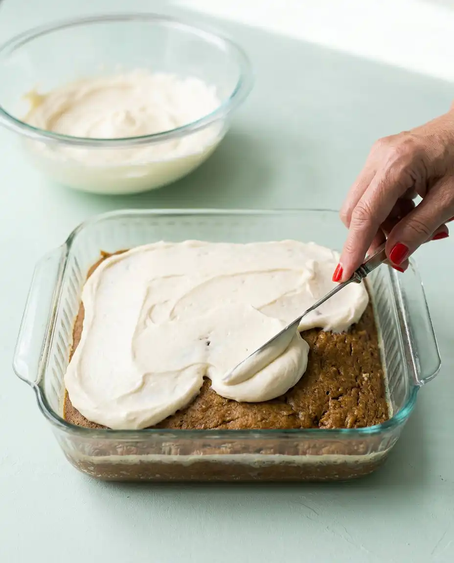 A single square slice of Old-Fashioned Zucchini Cake on a vintage white plate with a fork.