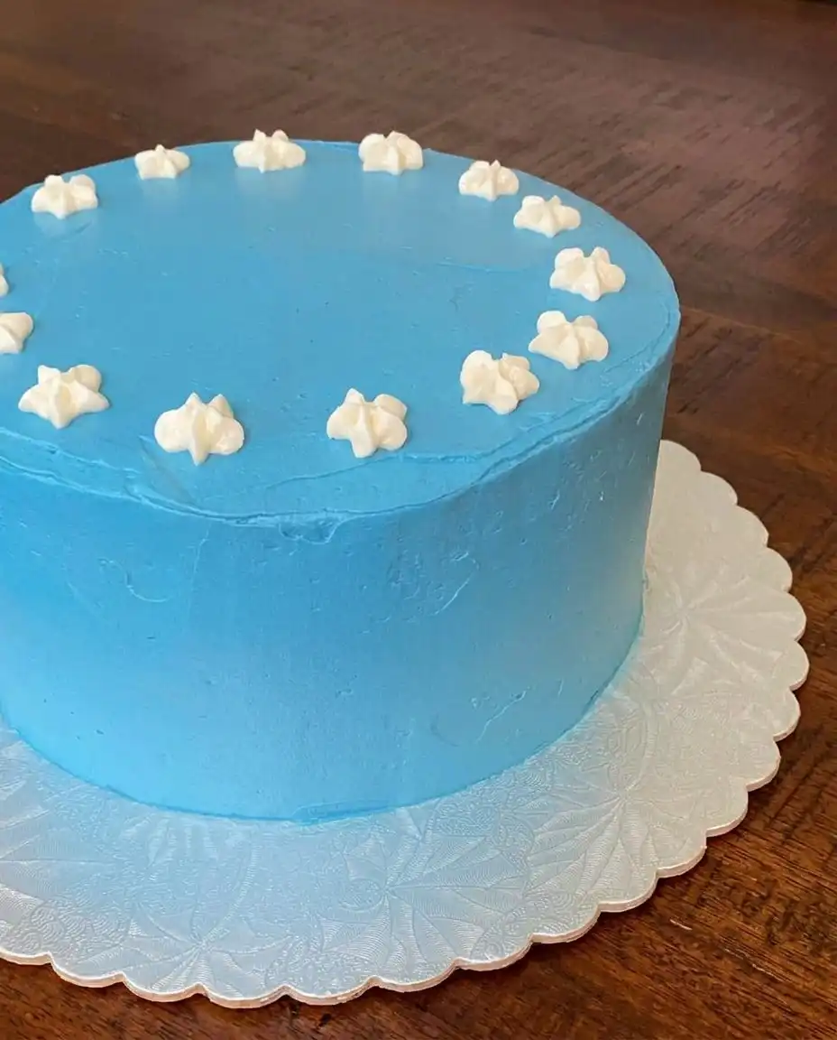 Red white and blue fourth of july poke cake decorated like an american flag