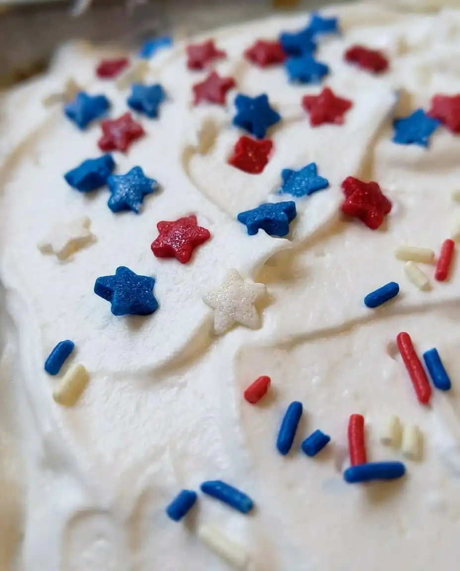 Red, White & Blue Patriotic Poke Cake 10 Cross section of a Red White and Blue Patriotic Poke Cake showing internal color stripes