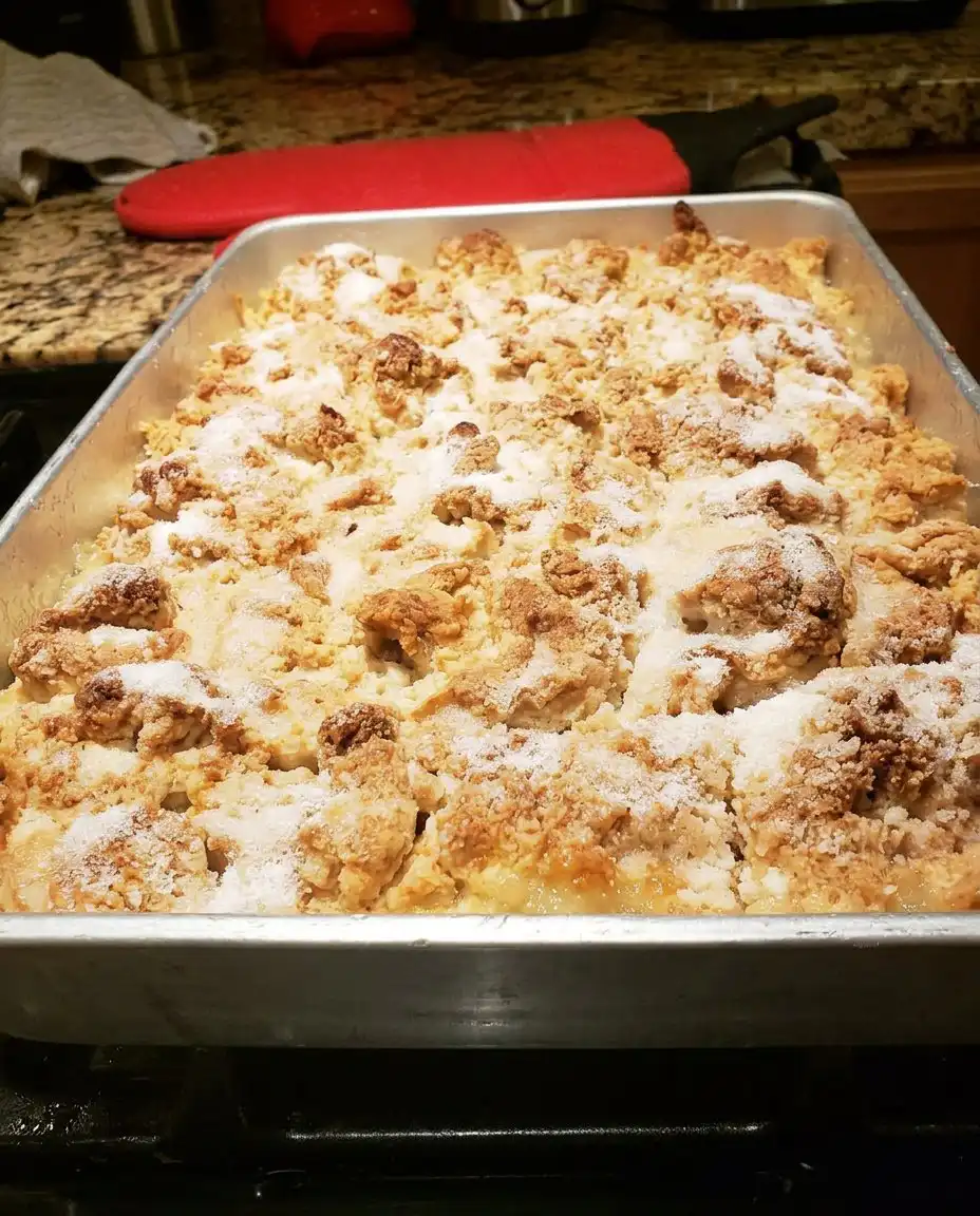 Paula Deen Peach Cobbler 10 A golden brown Paula Deen Peach Cobbler in a glass baking dish with bubbling peaches