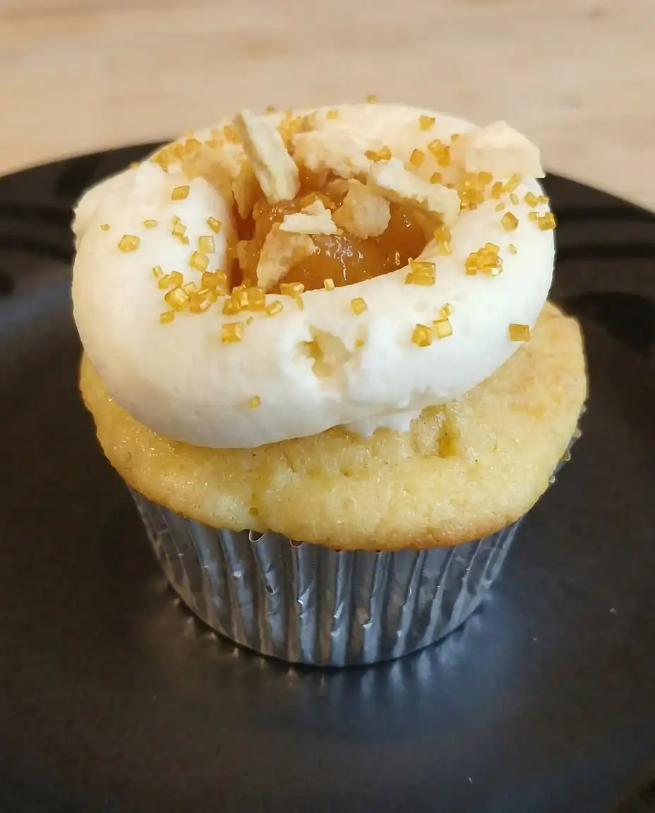 A tray of peach and honey cheesecake cupcakes served with coffee