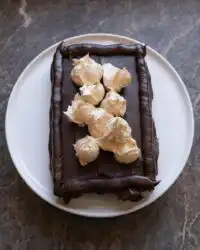 A close up of Peanut Butter Fudge Cake showing distinct chocolate and peanut butter layers