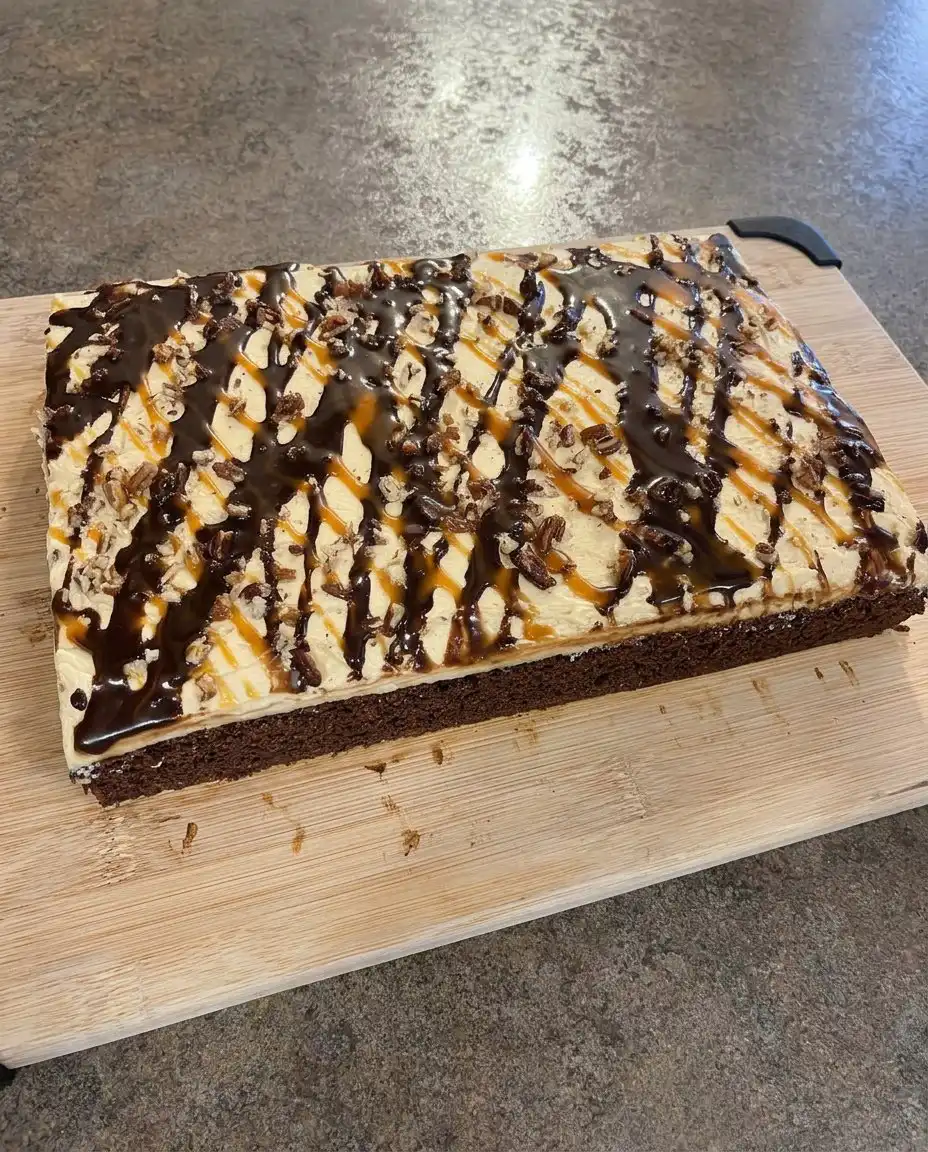 Chocolate Turtle Cake 14 A clean slice of chocolate turtle cake on a white plate with caramel drizzle