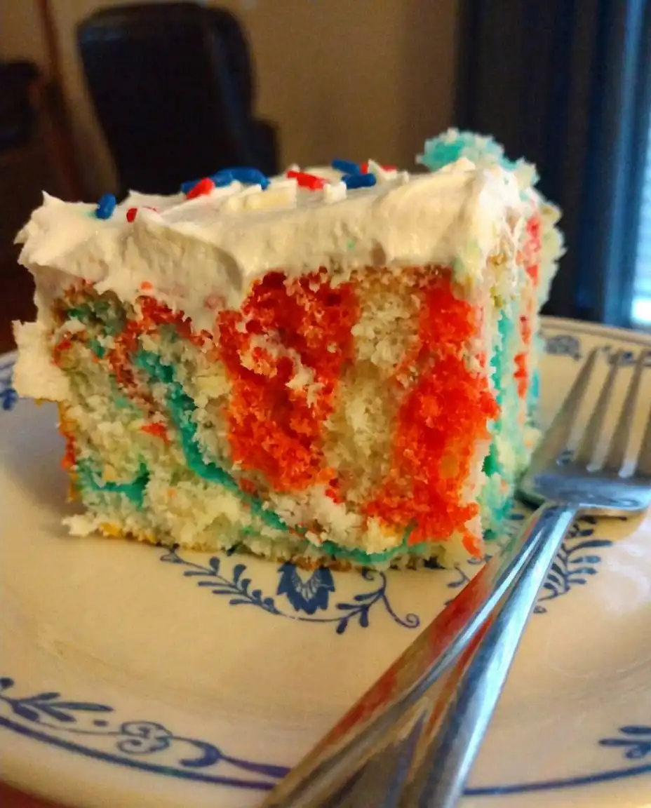 Red, White & Blue Patriotic Poke Cake 13 Using a wooden spoon handle to poke holes in a white sheet cake