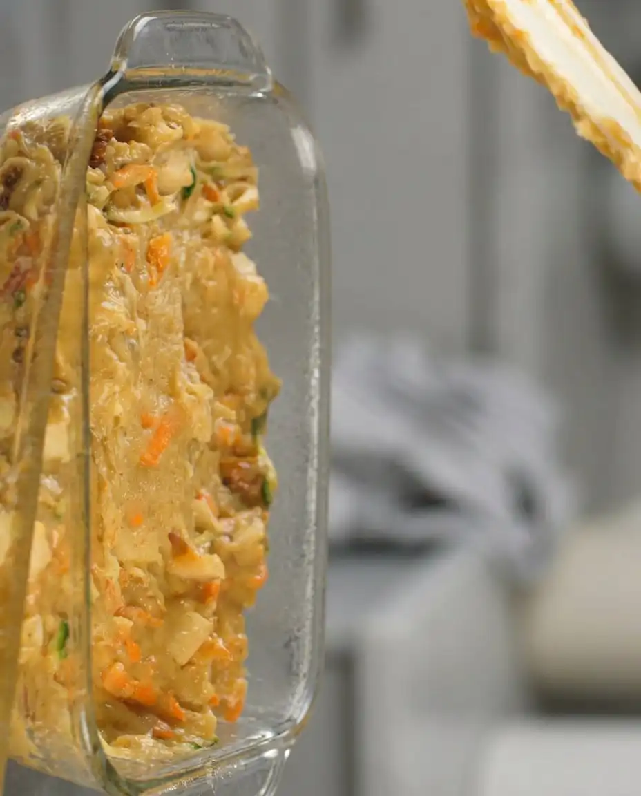 Carrot Apple Zucchini Bread 13 Folding grated zucchini into bread batter with a spatula