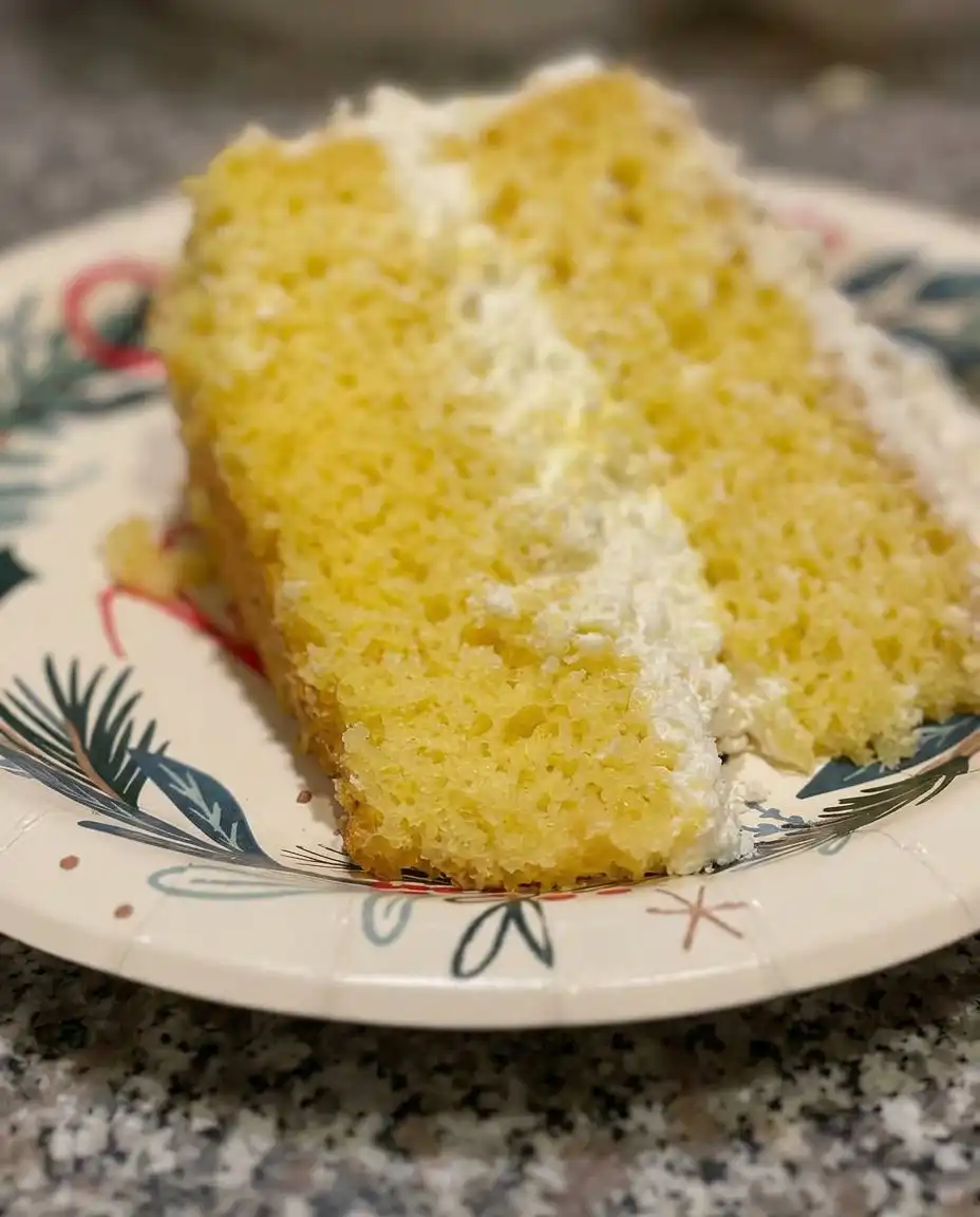 Slicing a chilled Italian Lemon Cream Cake with clean edges