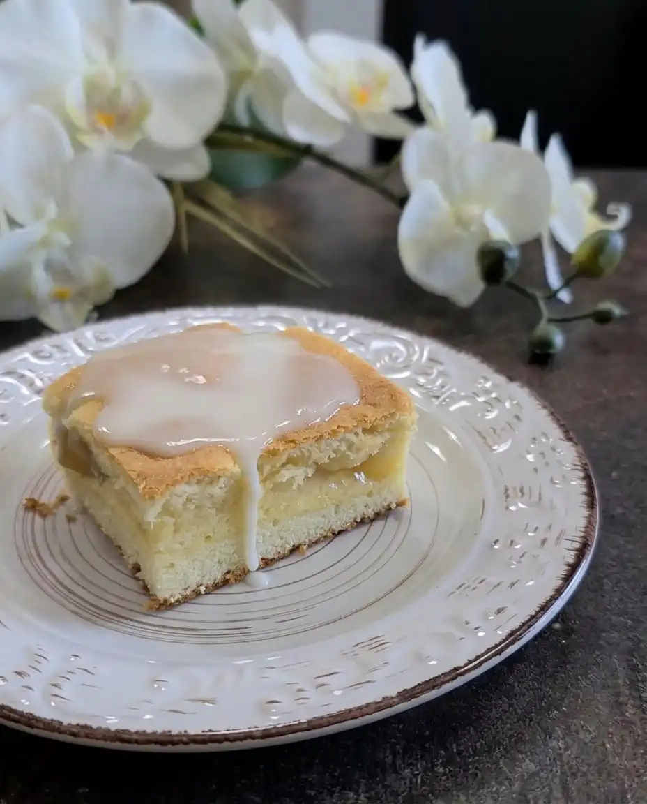 A square of Peaches and Cream Bars next to a small cup of coffee.