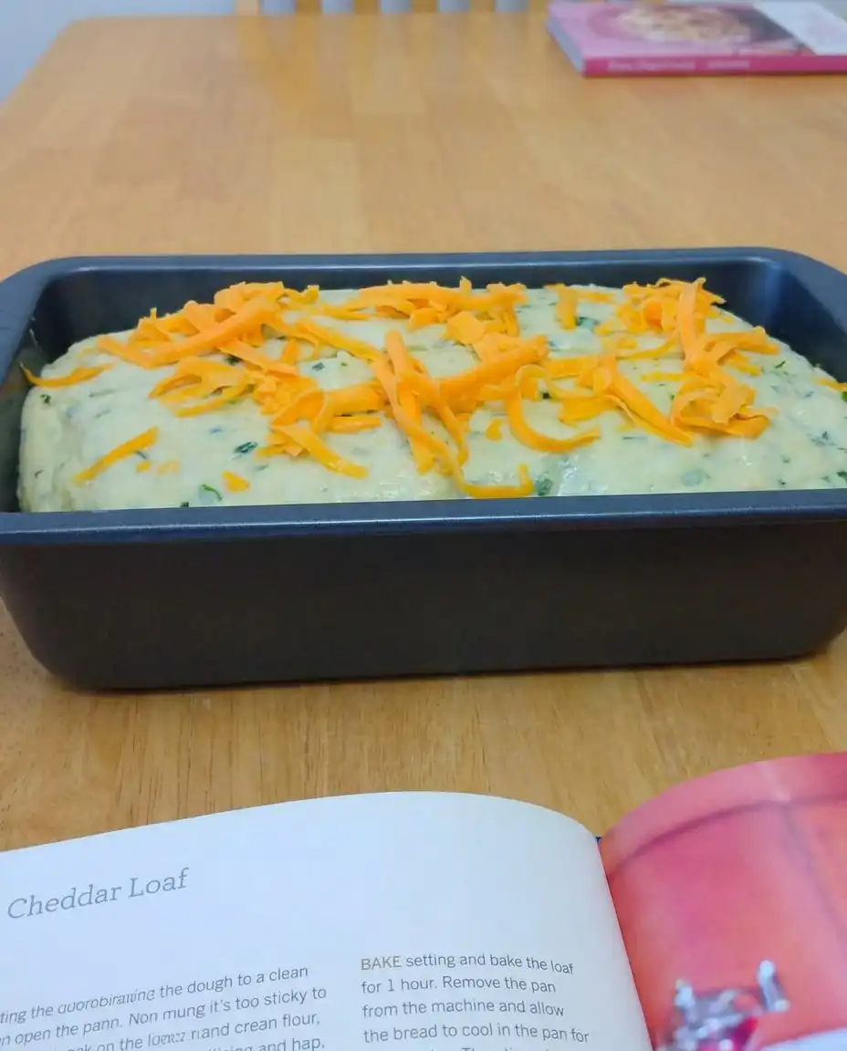 A slice of zucchini bread with melting butter on a white plate