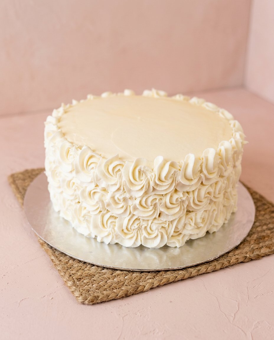 Peach Buttercream Birthday Cake 16 A clean slice of Peach Buttercream Birthday Cake showing the internal fruit layers.