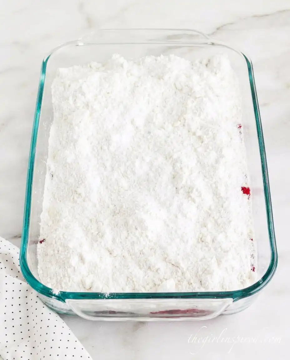 Ingredients for strawberry cheesecake dump cake including pie filling and cake mix