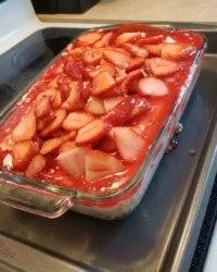 A close up of Strawberry Heaven showing the distinct layers of angel food cake, cream cheese, and strawberry glaze.
