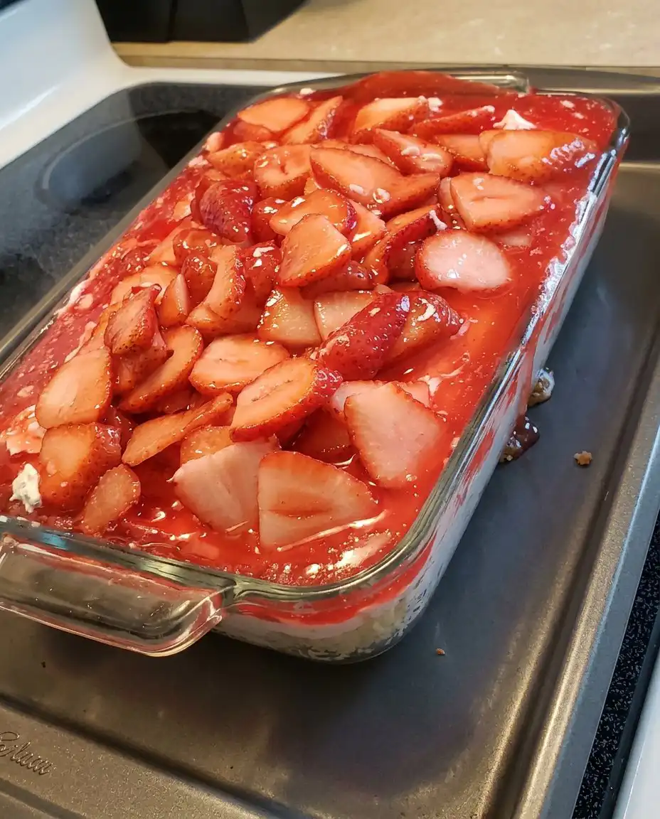 A close up of Strawberry Heaven showing the distinct layers of angel food cake, cream cheese, and strawberry glaze.