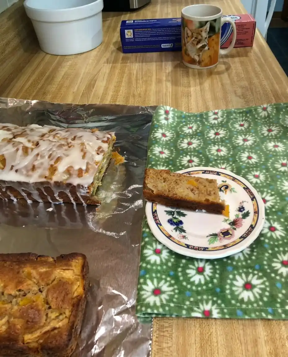Heavenly Peach Bread 10 A golden loaf of Heavenly Peach Bread sliced on a wooden board