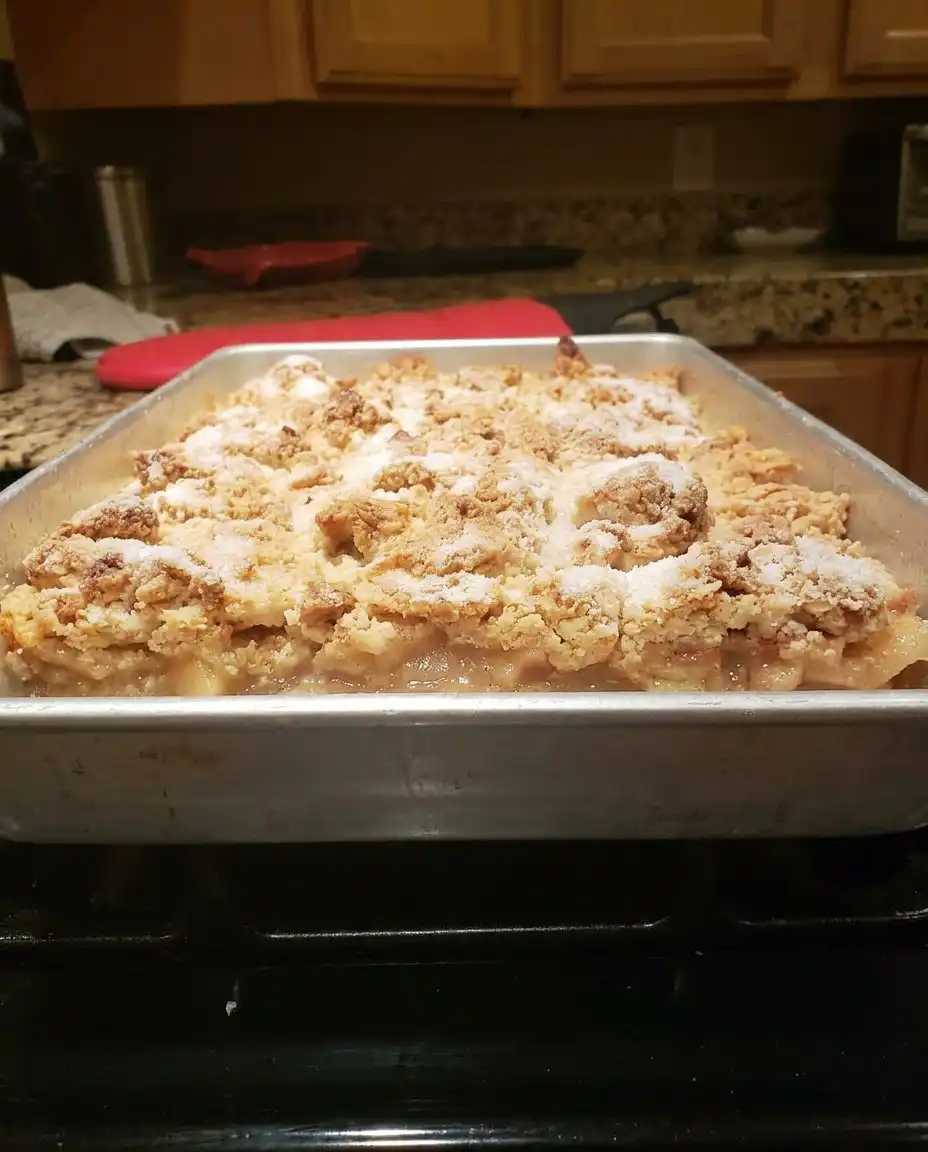 Paula Deen Peach Cobbler 14 A bowl of warm peach cobbler topped with a melting scoop of vanilla ice cream