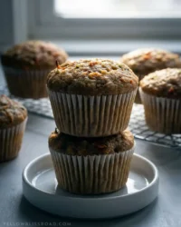 Close up shot of Zucchini Carrot Oatmeal Muffins showing the moist crumb and oat texture