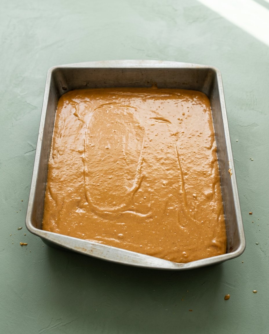 Pumpkin Spice Cake 15 Warm Pumpkin Spice Cake baking beautifully in a rectangular metal pan inside a preheated oven.
