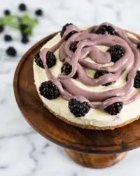 A sliced Blackberry Vanilla Cake showcasing the moist cake layers and blackberry curd filling.