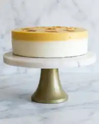 A close up slice of Classic Mango Mousse Cake showing golden sponge and silky mango layers.