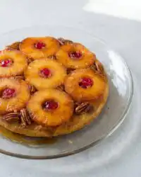 A golden slice of Classic Pineapple Upside Down Cake topped with a caramelized ring and cherry