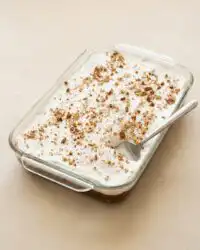 A freshly baked Classic Pumpkin Crunch Cake in a baking dish showing the golden brown pecan topping.