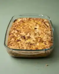 A clean slice of Classic Pumpkin Dump Cake showcasing the layered custard base and a crunchy pecan topping.