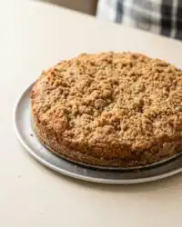 A golden brown Peach Streusel Coffee Cake with fresh peach slices and a cinnamon crumble topping.