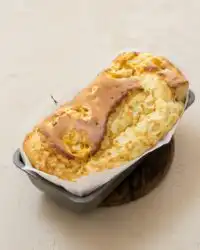 A slice of moist Mango Yogurt Cake served on a vintage ceramic plate